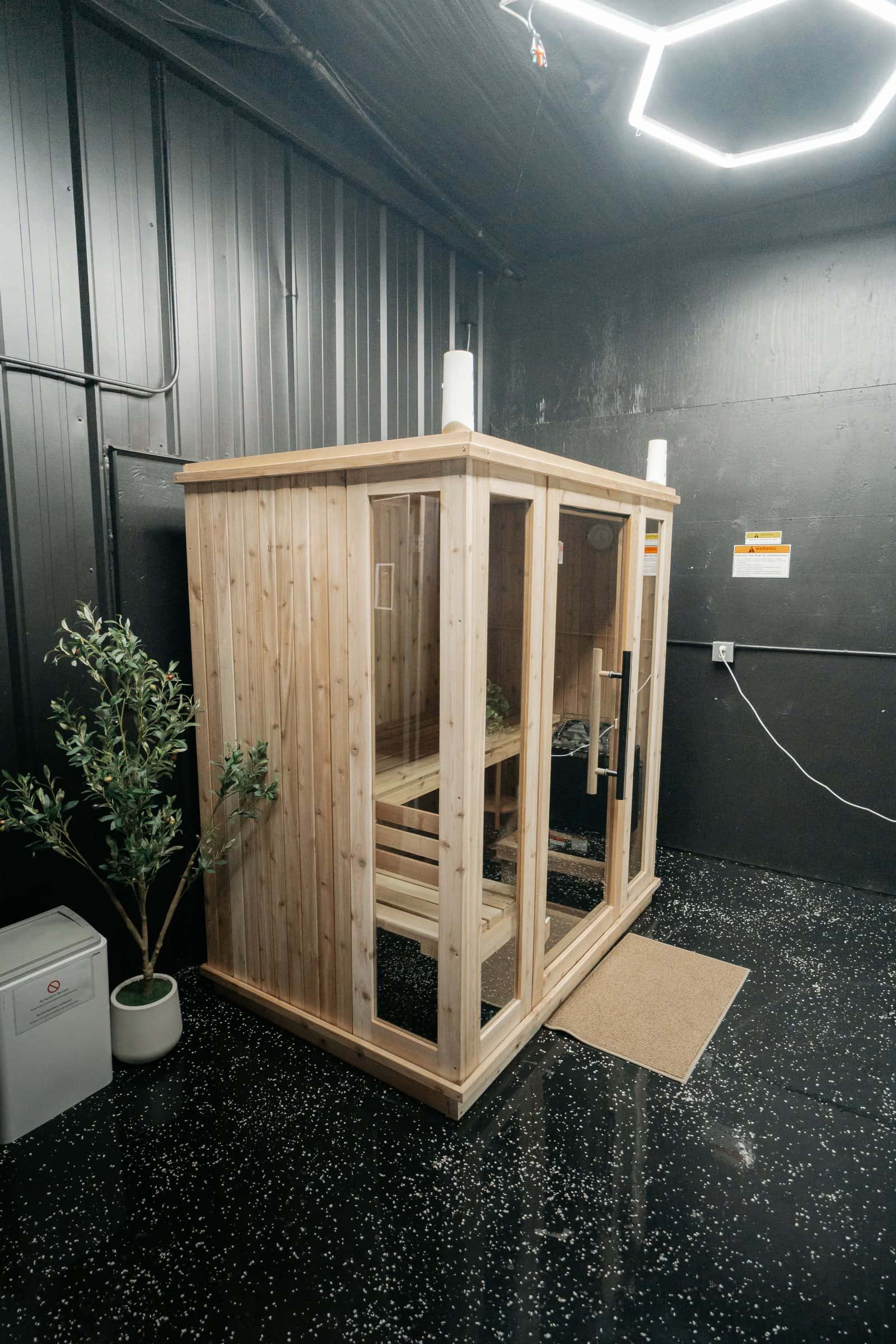 The wooden sauna cabin under hexagon ceiling lights