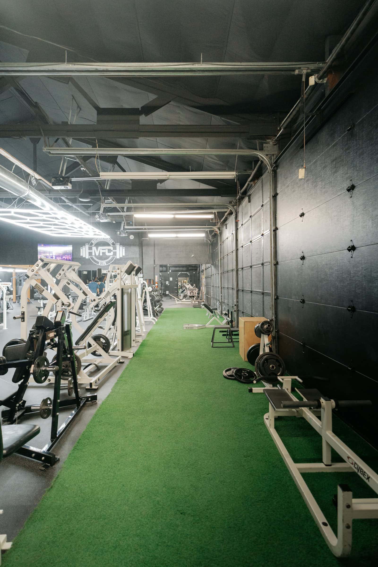 Stretching area: a green turf lane by the entrance
