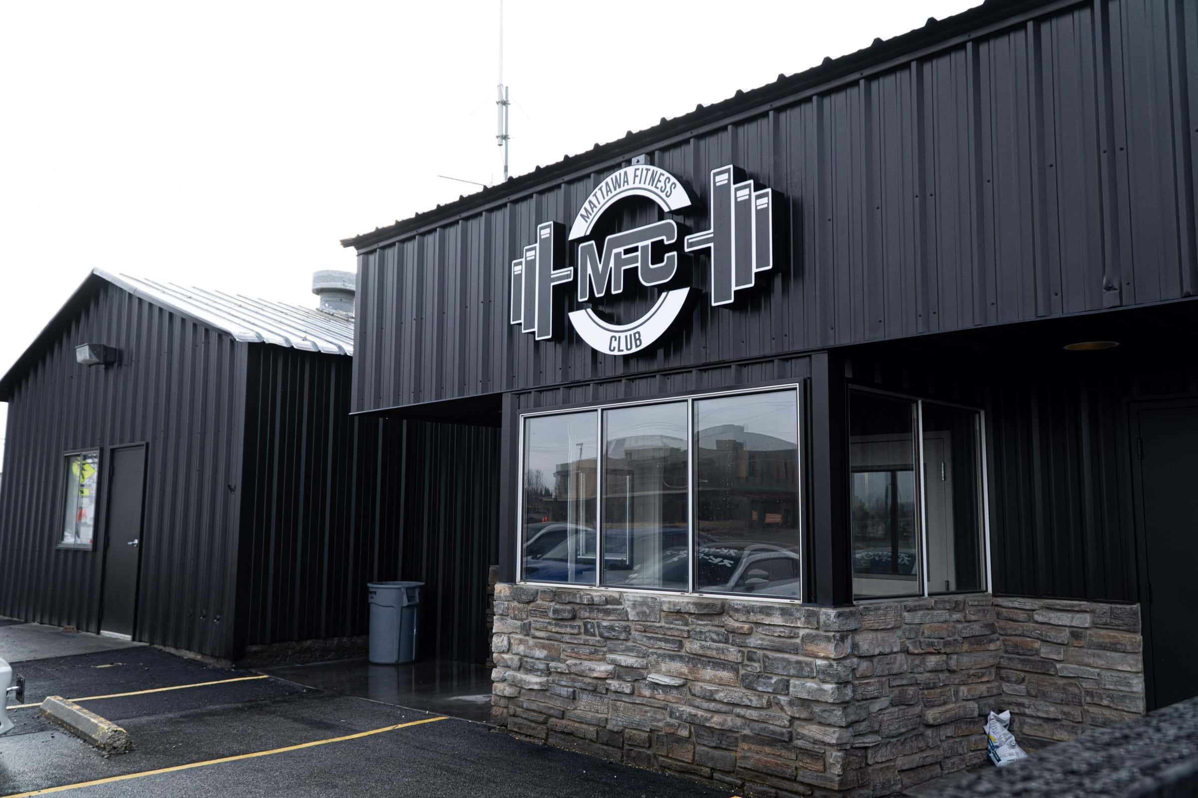 Outside Mattawa Fitness Club: black building with the MFC sign over the entrance